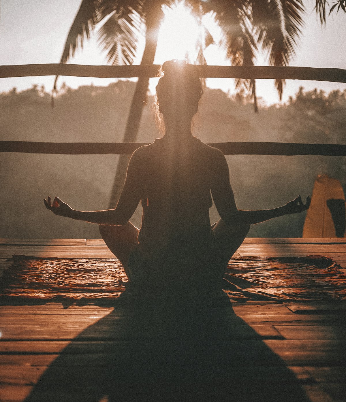 Person meditating outdoors on a dock